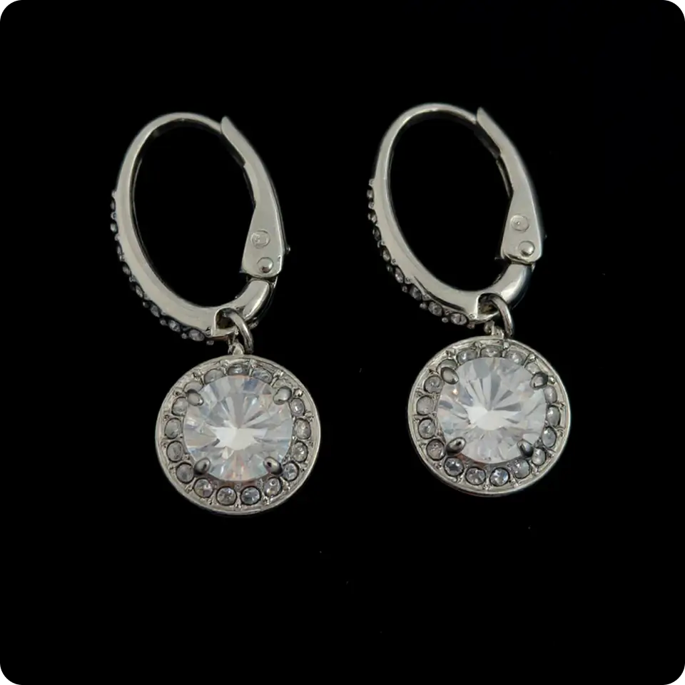 Place the earrings on clean black background with professional studio lighting