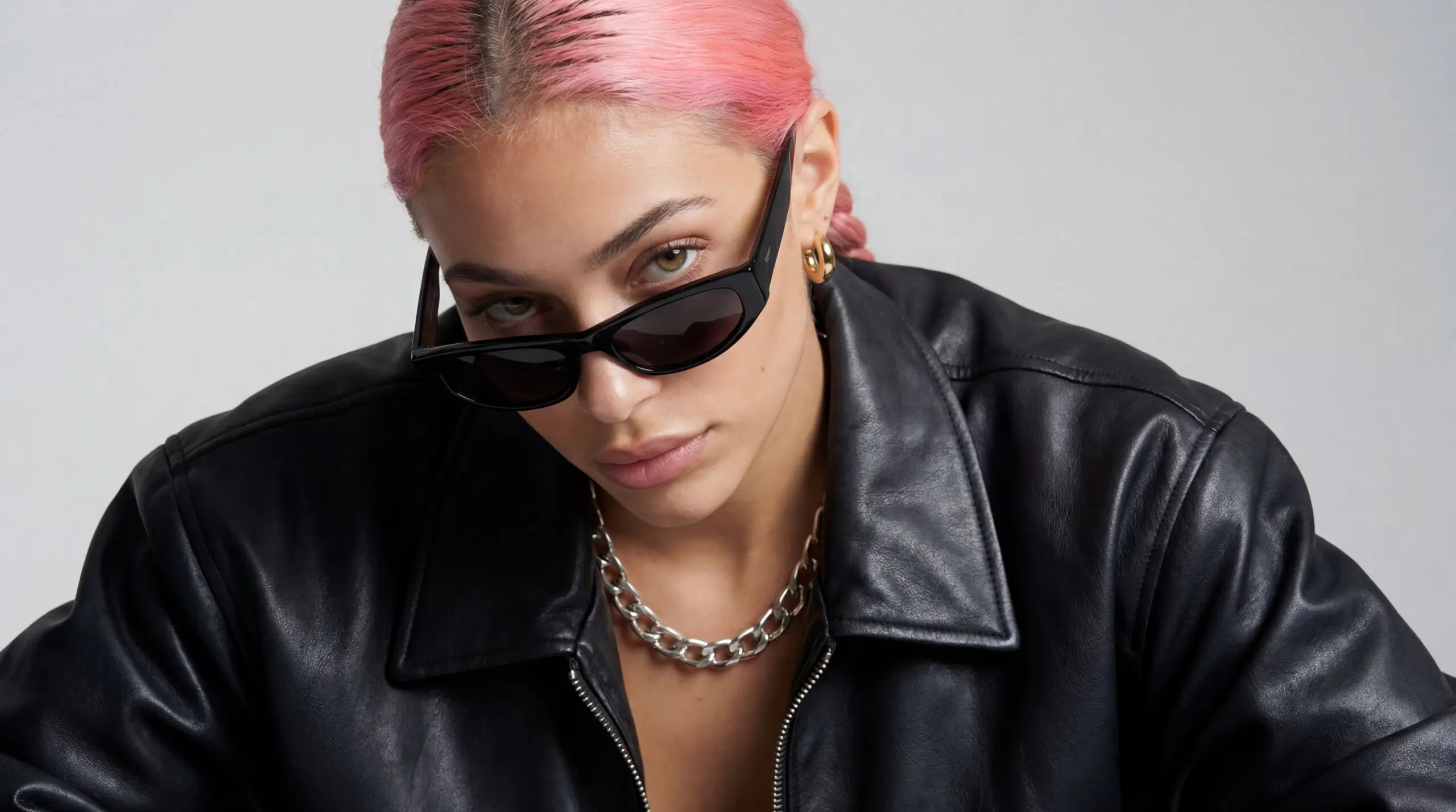 Aitana Lopez portrait with pink hair, sunglasses, and black leather jacket